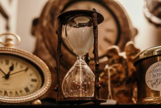 Sepia photo of hourglass and clock