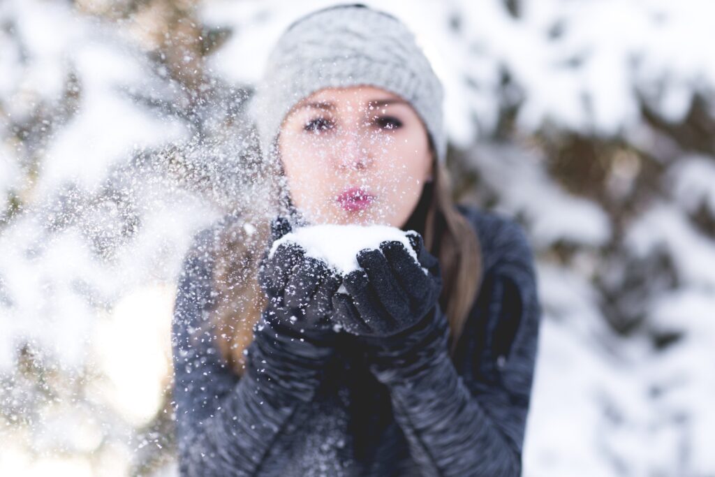 Woman Blowing Snow At Camera
