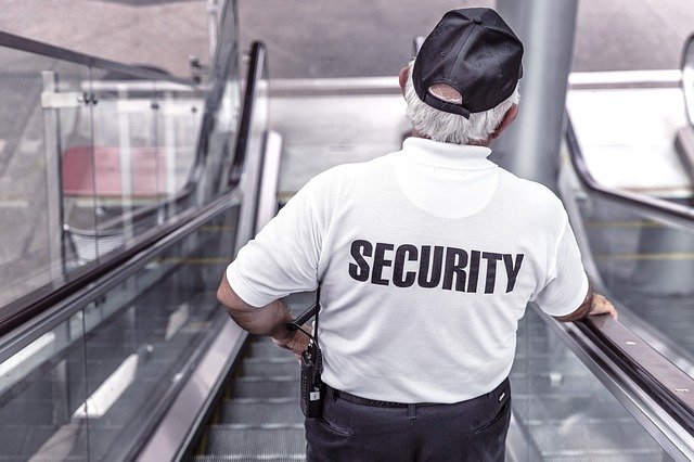 Security Guard going down escalator