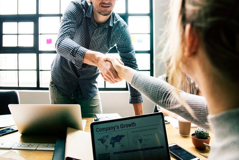 Man Shaking Hand With Woman Over Business Deal