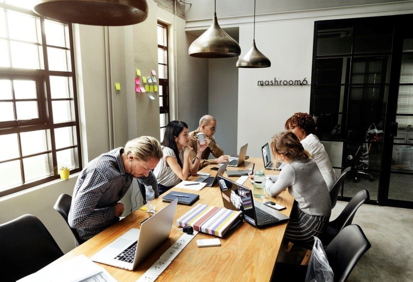 Group of people sitting around a meeting table