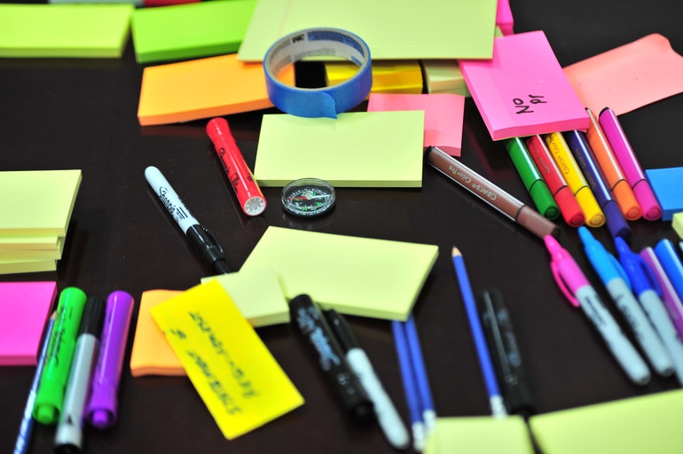 Post-it notes, pens and pencils