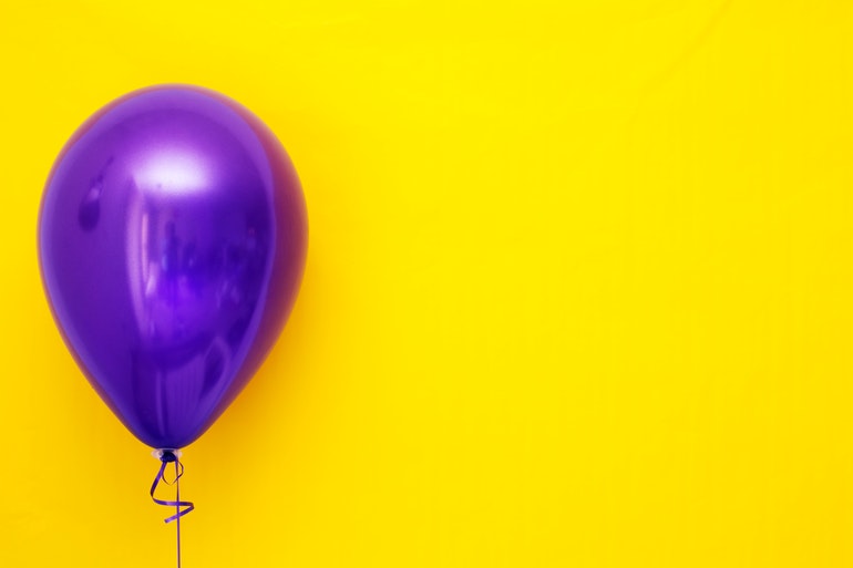 Purple balloon on a yellow background