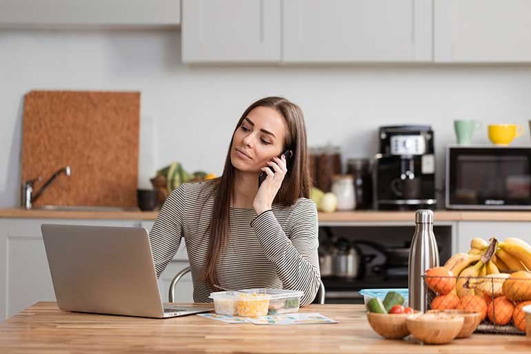 Woman working at a kitchen table