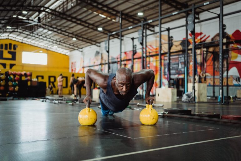 Man exercising with kettle bells
