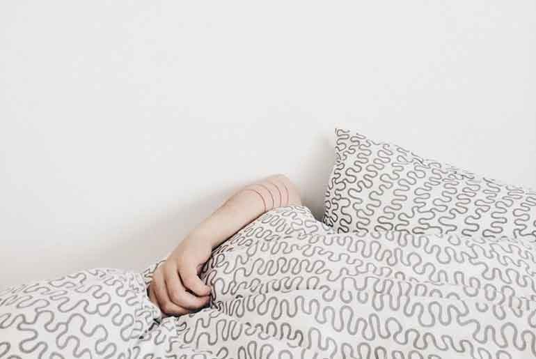 Person Sleeping Under A Duvet