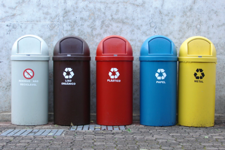 A row of colourful recycling bins