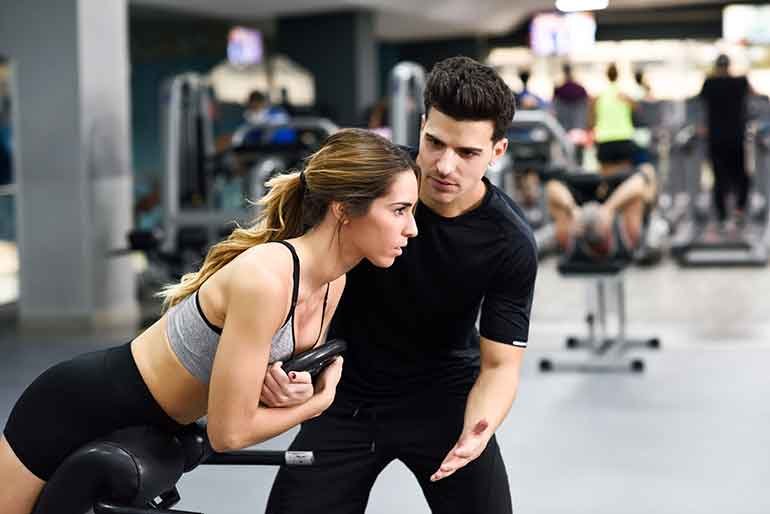 Man training women in a gym