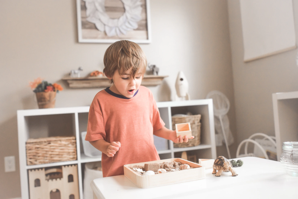 Child standing in front of square storage shelves