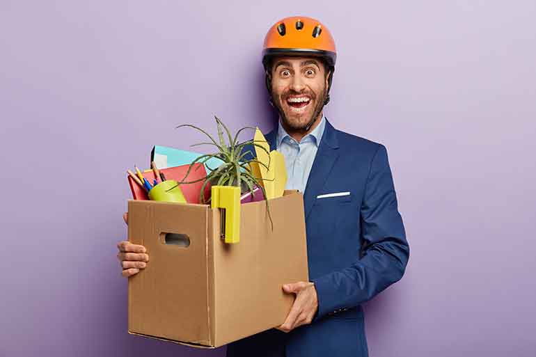 Businessman with a moving box full of belongings