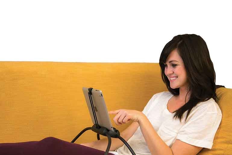 Woman on sofa with tablet stand