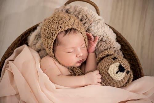 Baby Wearing Brown Knit Cap While Sleeping