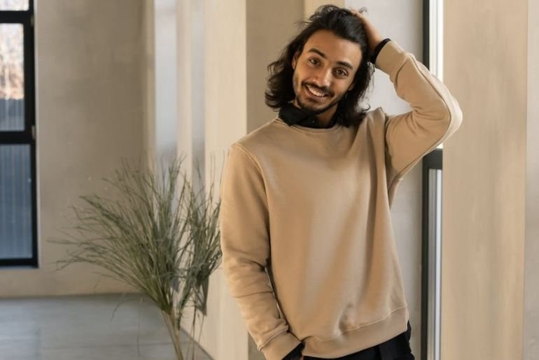 Smiling man wearing a baggy jumper