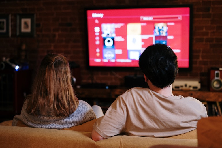 Couple watching a large screen TV