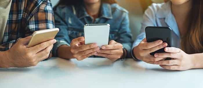 Group of people looking at their phones