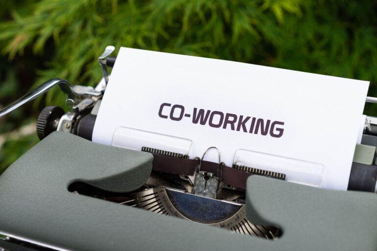 The word "Co-working" written on paper inserted into a typewriter