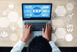 Person using a laptop with the word "ERP" on the screen