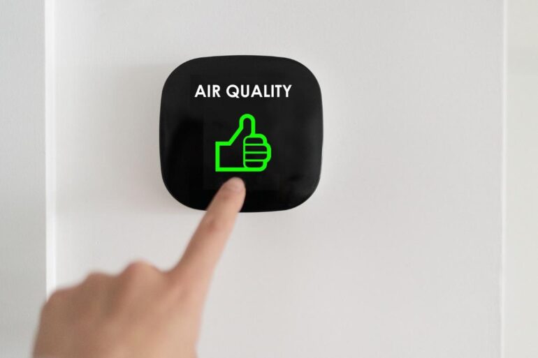 Air quality monitor with a thumbs up symbol on it