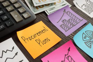 The word "procurement plans" and several graphs drawn on coloured sticky notes