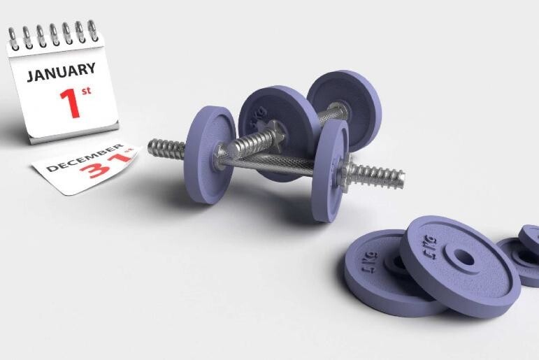 Dumbbells and weights next to a calendar that says "January 2022"