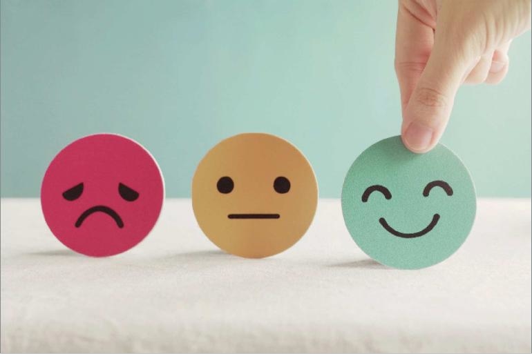Person choosing a happy face