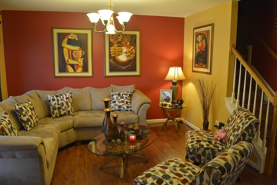 Bright yellow living room with a statement orange wall