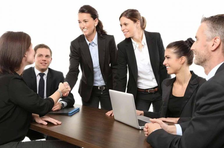 Profession people shaking hands at the start of a meeting