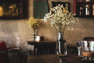 Vintage decor with the focus on flowers in a milk bottle