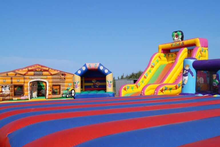 Brightly coloured Inflatable slide and bouncy castles