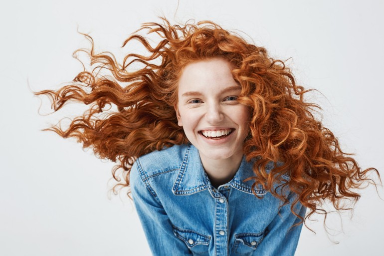 Smiling woman with curly red hair