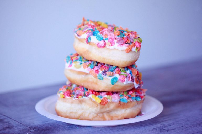 Stack of donuts covered in sprinkles