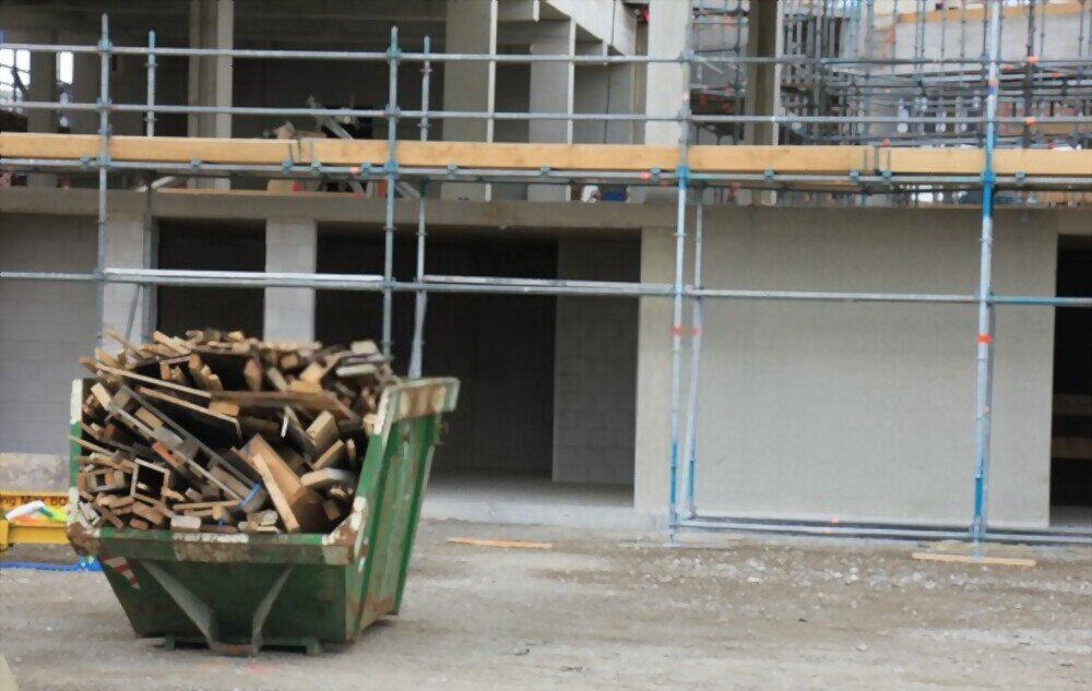 A skip filled with wood at a construction site