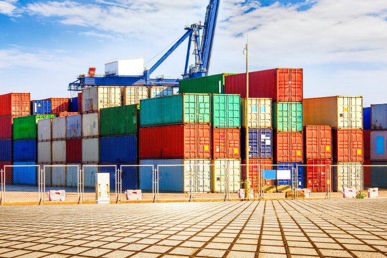 A pile of multi-coloured containers on a dock