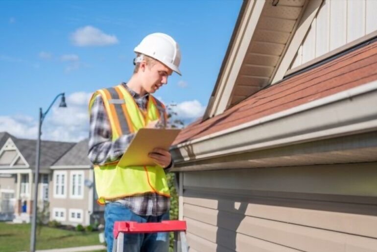 Person writing on a clipboard while looking at a roof