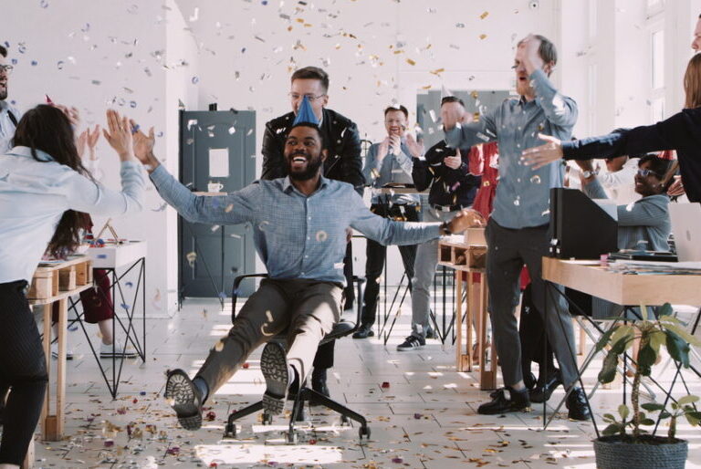 People having a party in an office with party hats and confetti