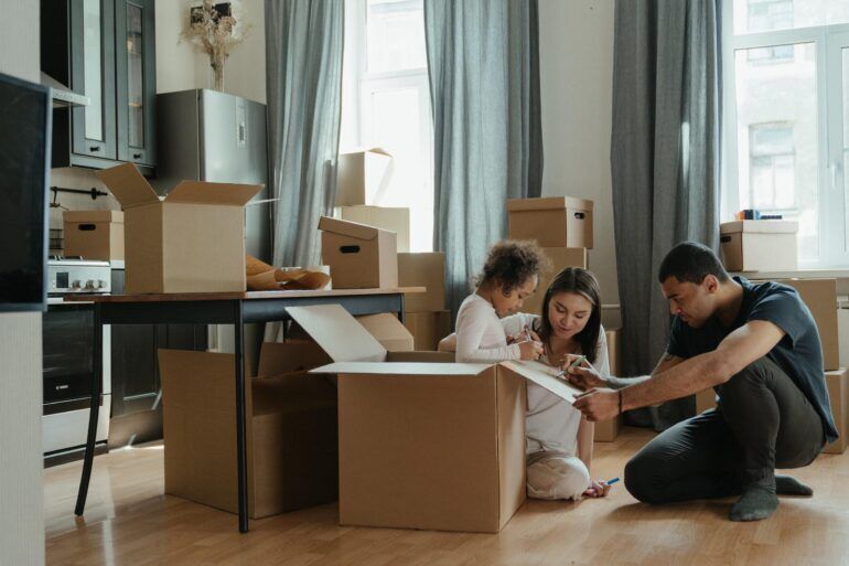 A family packing up boxes in their kitchen