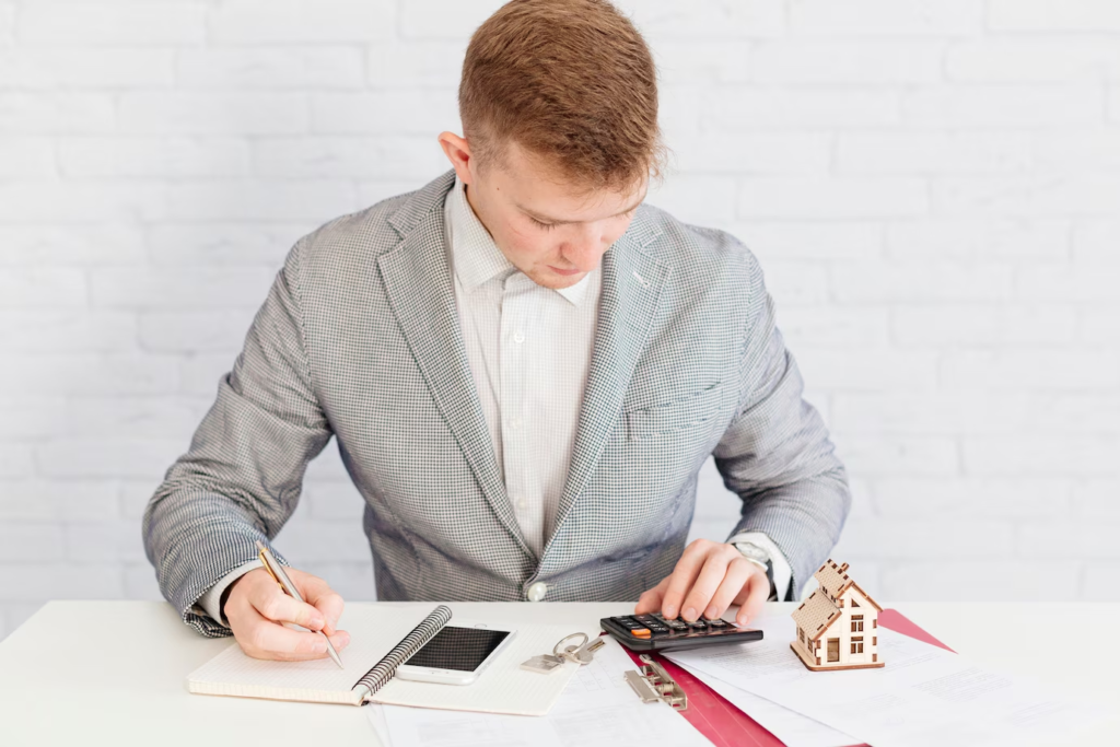 A real estate agent using a calculator